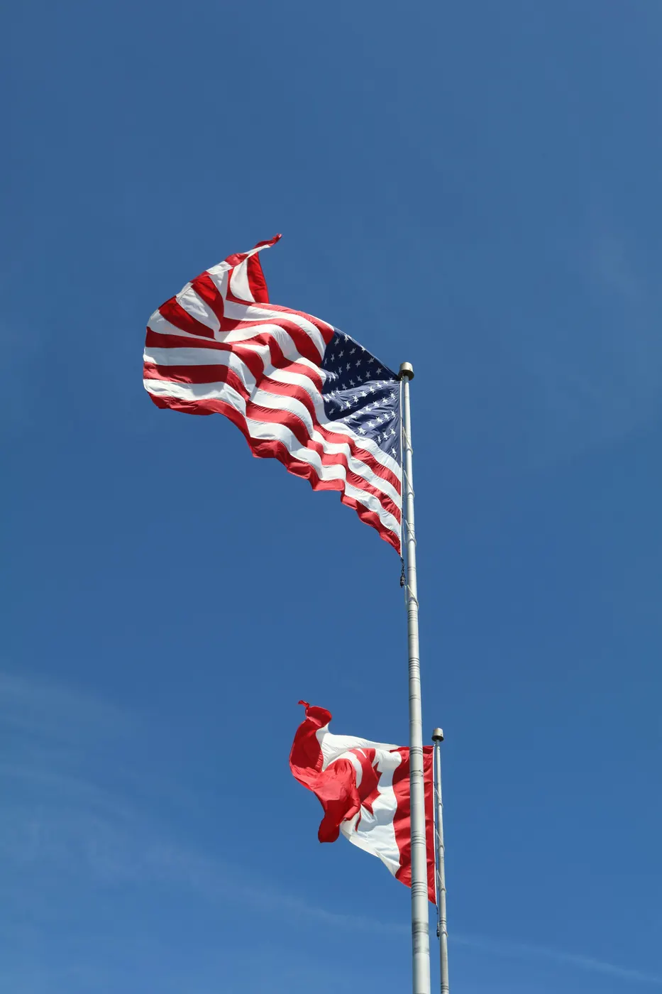 American and Canadian flags side by side — Detroit 3PL licensed customs broker for US-Canada cross-border logistics